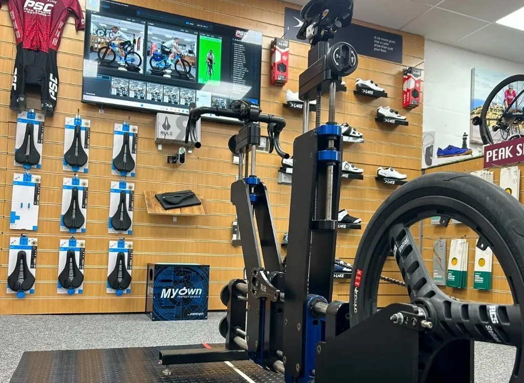 Professional bike fitting jig in the PSC studio with analysis screen behind